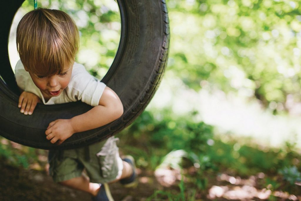 Little Boy on a Tyre Swing - Fiteni Homes