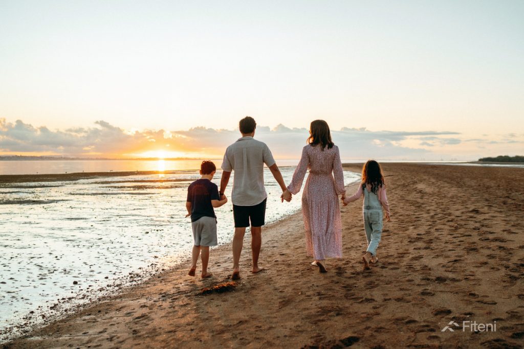 Fiteni Homes Community - Family Walking Along the Beach